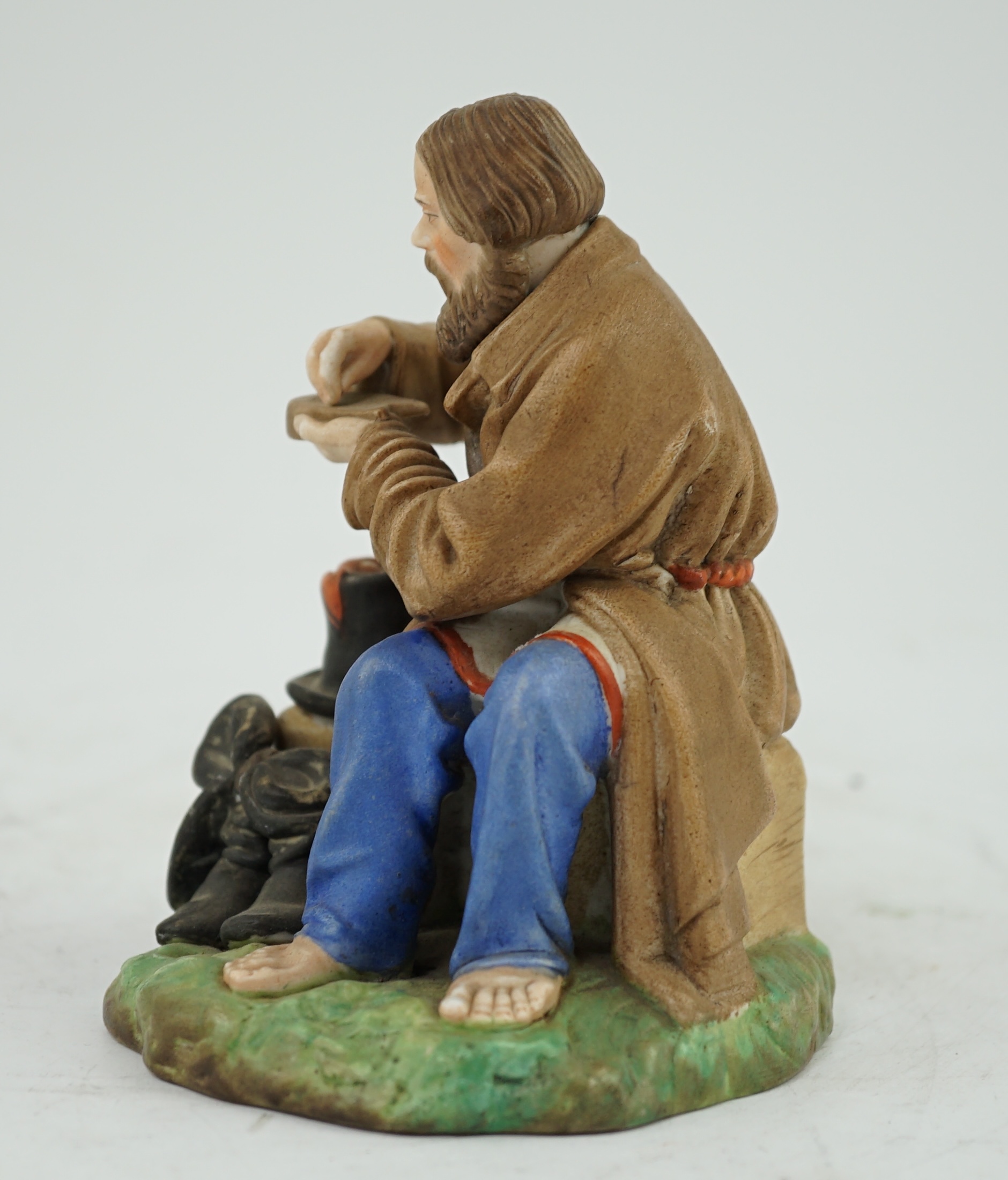 A Russian Gardner factory coloured biscuit porcelain figure of a man salting bread, late 19th century